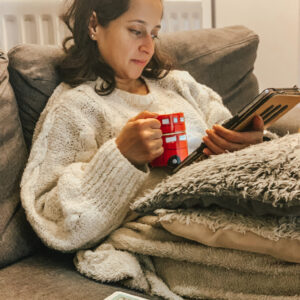 White jumper reading iPad