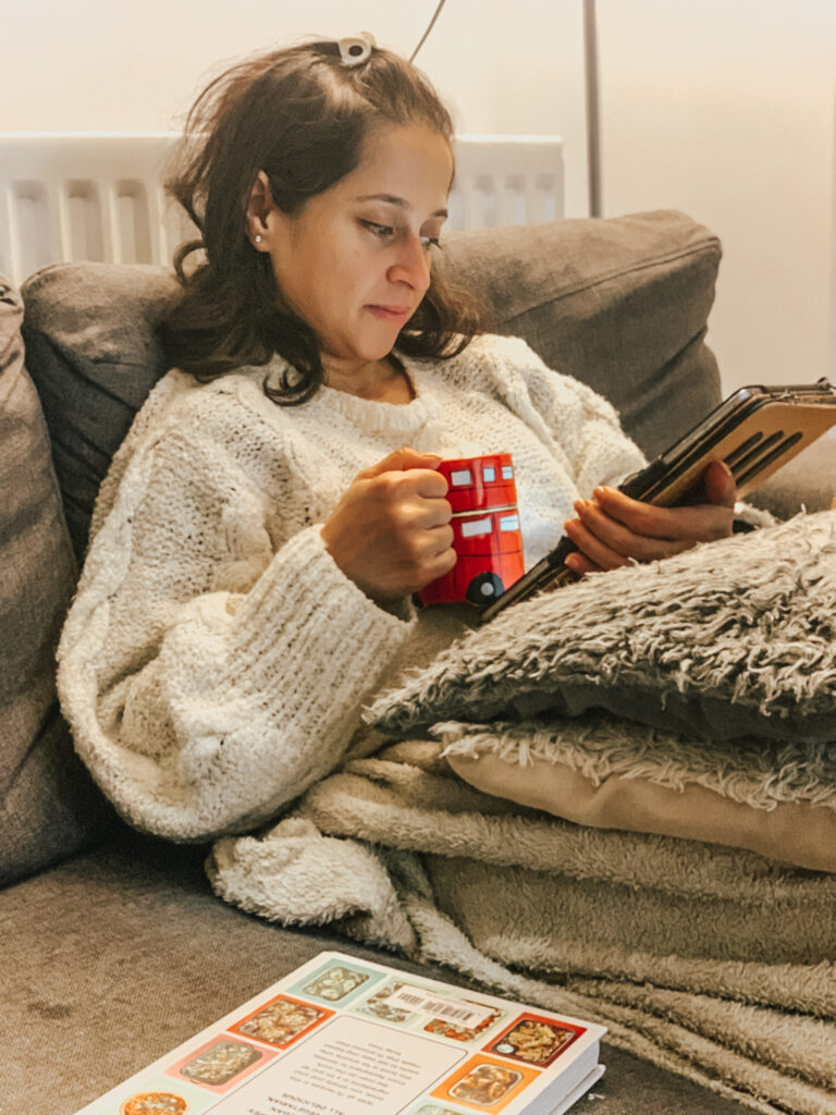 White jumper reading iPad
