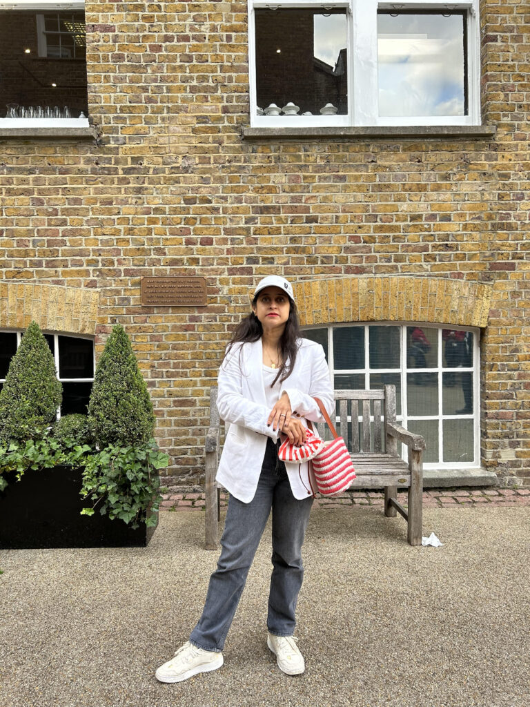 white baseball cap, white blazer and jeans